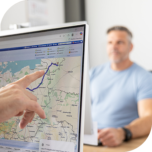 Hand pointing at route on computer map