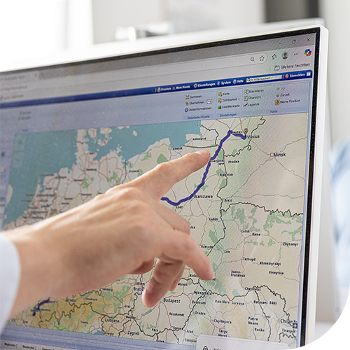 Hand pointing at route on computer map