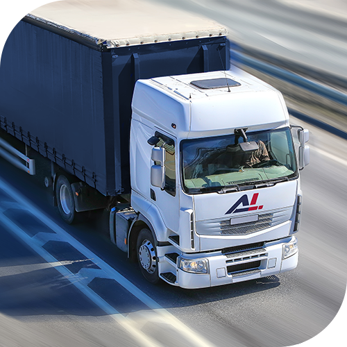 White semi-truck driving on highway with covered trailer